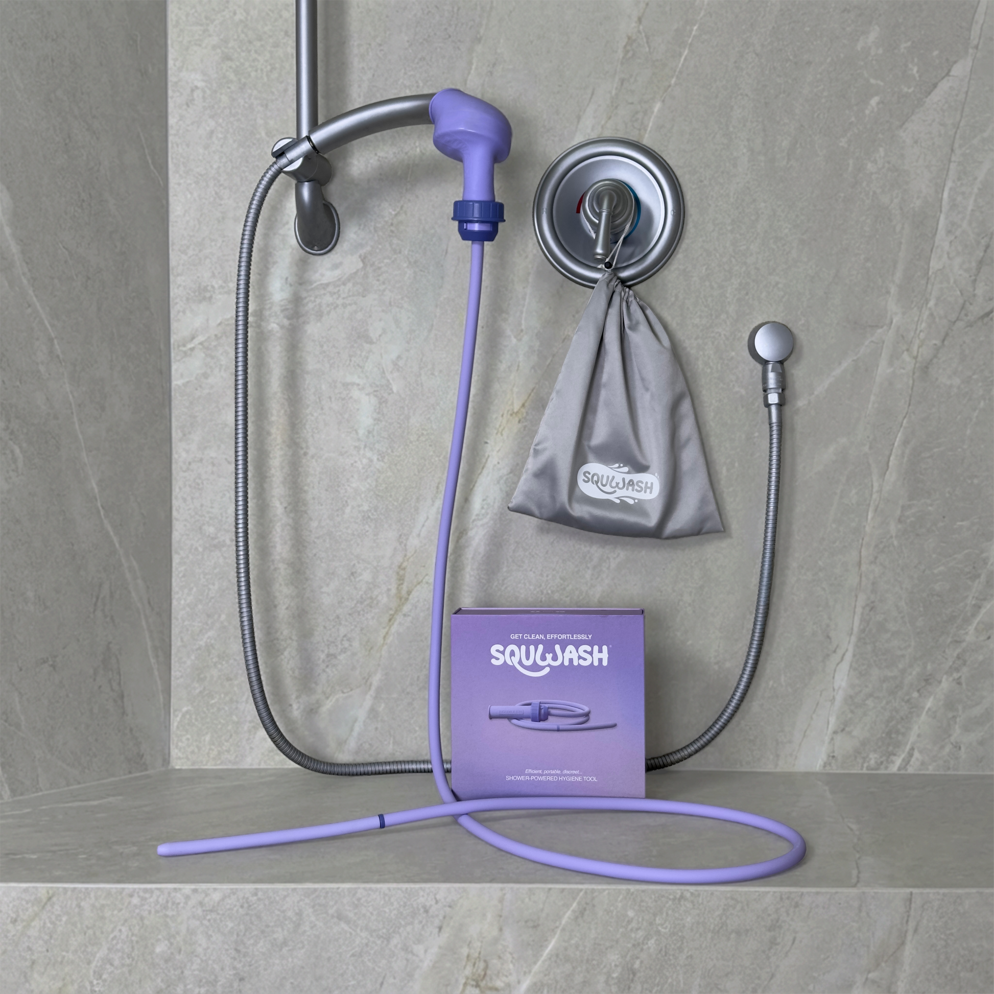 Portable shower douche and enema kit attached to shower head displayed with box and travel bag in modern bathroom setting