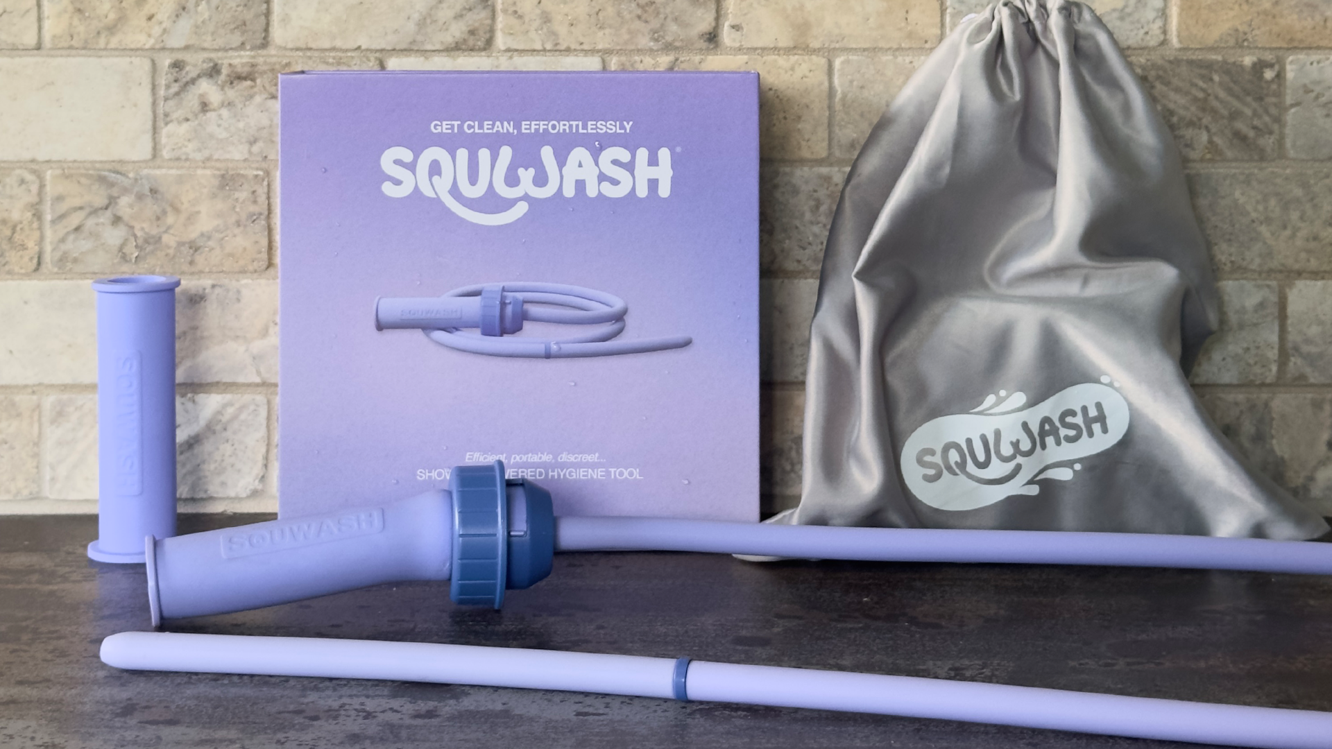 Load video: Video showing Squwash Slip-on Shower Douche attaching instantly to shower head demonstrating it's ease-of-use and tool-free attachment for travel, Squwash's platinum-cured silicone tip, adjustable pressure release, consistent air-bubble-free flow, and other features.